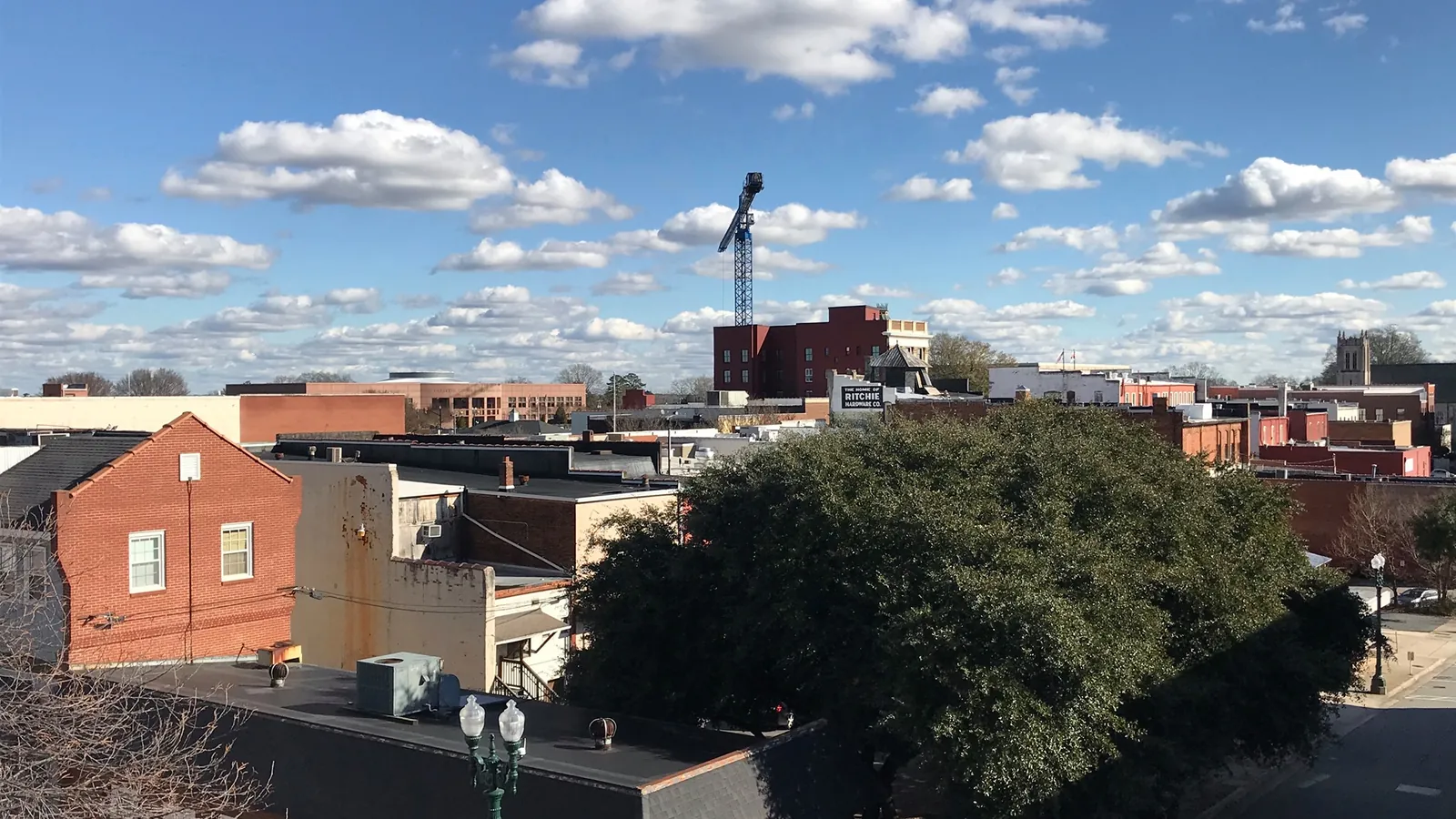Downtown Concord, NC rooftops under a blue sky, where Septic Samurai handles septic system repair for homes beyond the sewer lines