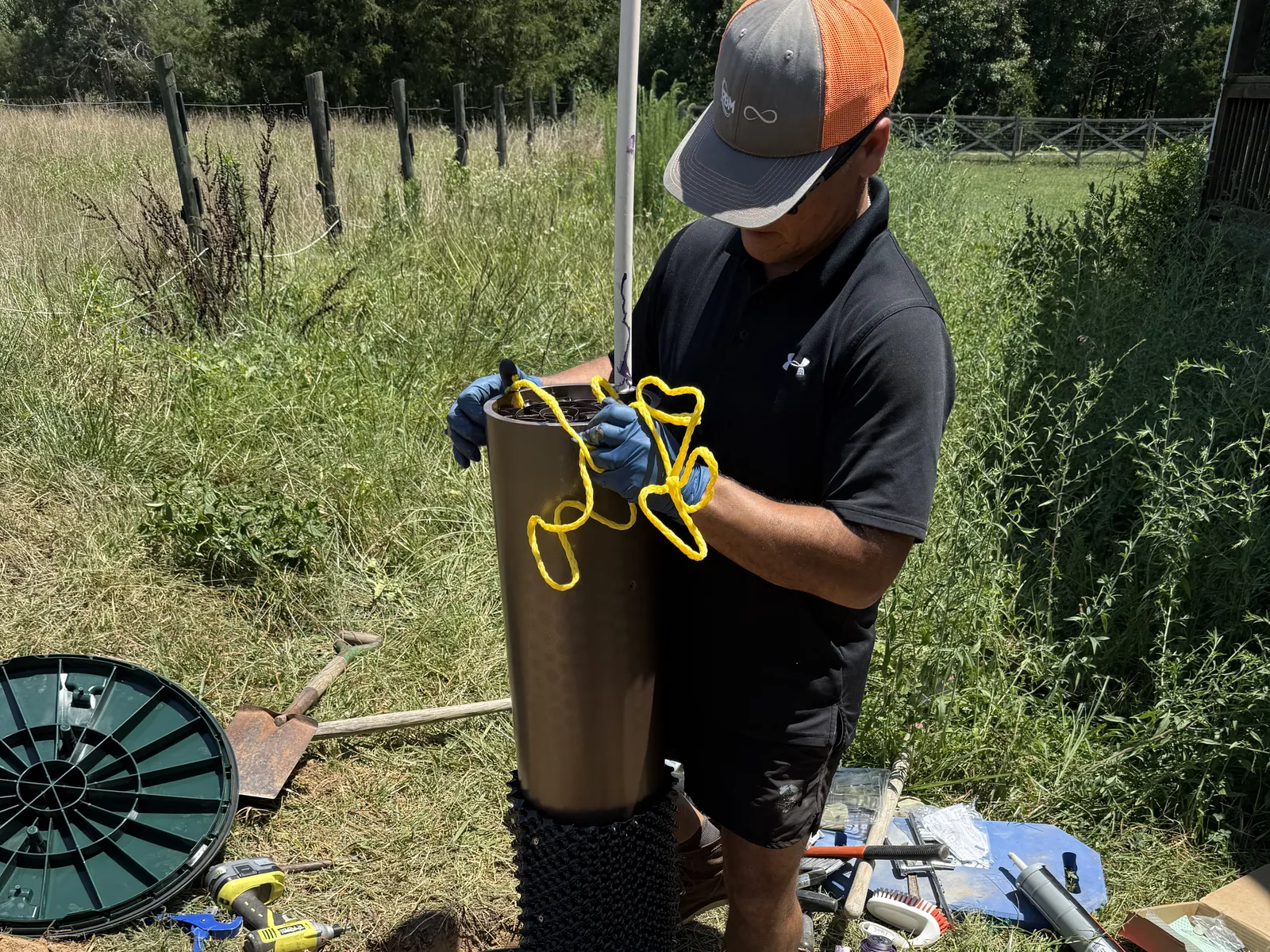 Septic Samurai crew setting a riser on a septic tank during a restoration install
